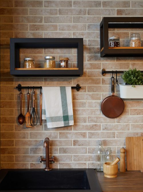 Vertical background image of kitchen interior with brick wall and rustic decor elements, copy space