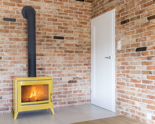 Room with red brick wall and a fireplace